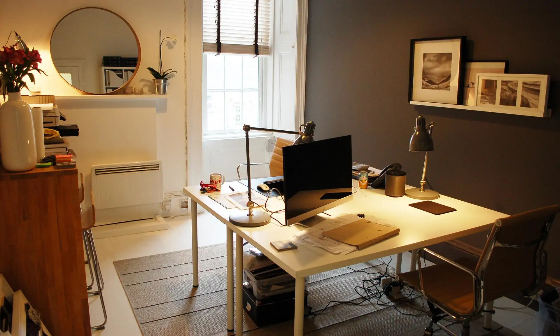 A home office with a table and desktop computer