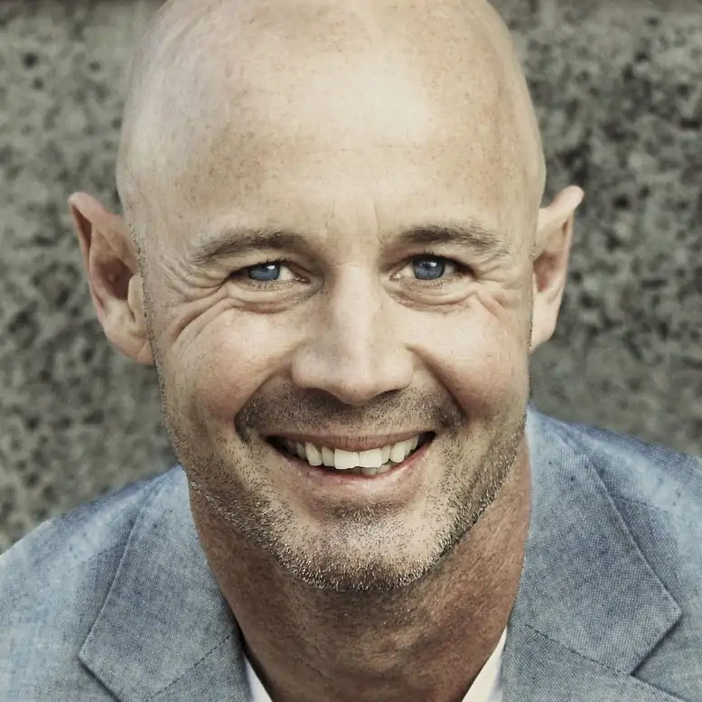 A smiling man with bald head